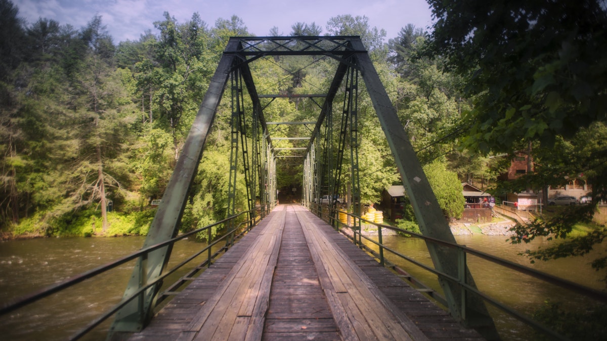 Bridge over Toccoa River in Blue Ridge GA at dusk with trees in the background